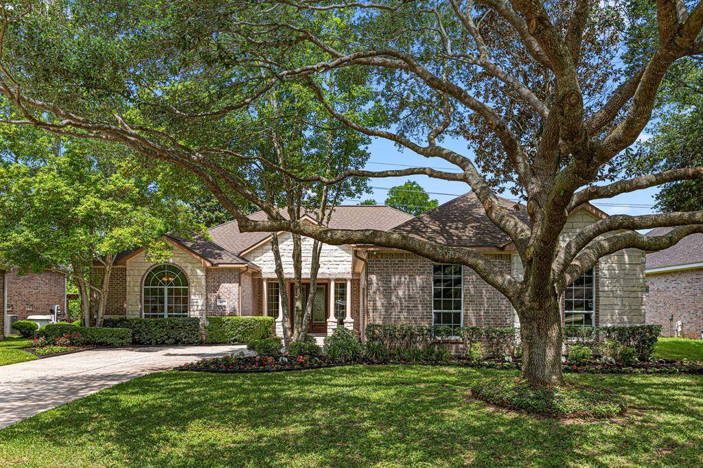 Nestled under mature trees, this extensively updated 4-Bedroom, 3-Full Bath home features a stunning stone and brick exterior, lush landscaping, and peaceful views of Pecan Lake—an ideal blend of comfort and nature.