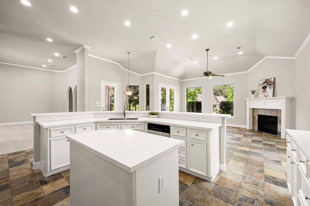 A long Breakfast Bar overlooks the Kitchen, providing additional seating and featuring an undermount stainless steel sink with a satin nickel gooseneck faucet.
