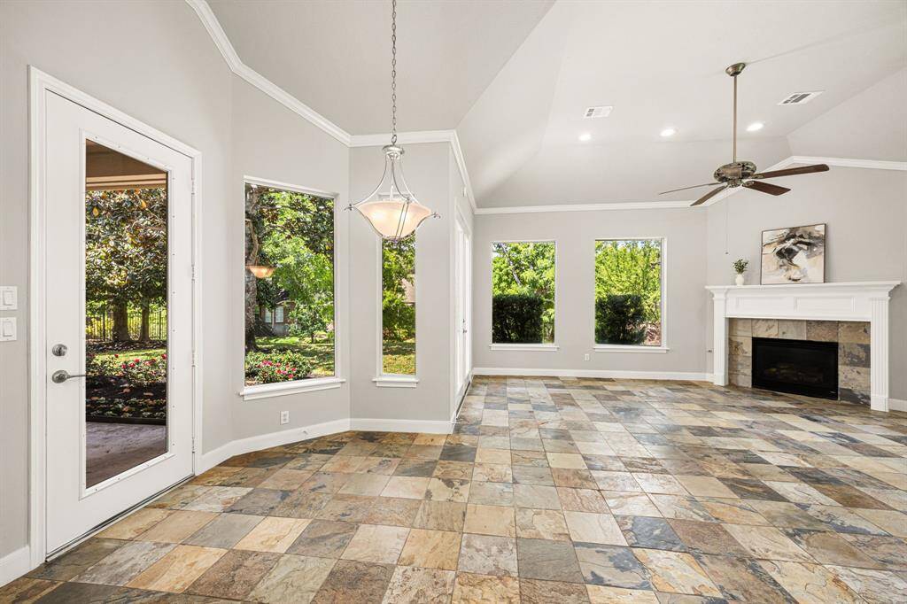 The Breakfast Room features a satin nickel chandelier, a side glass door leading to the covered back Patio, and ample space for a round table—perfect for enjoying your morning coffee.