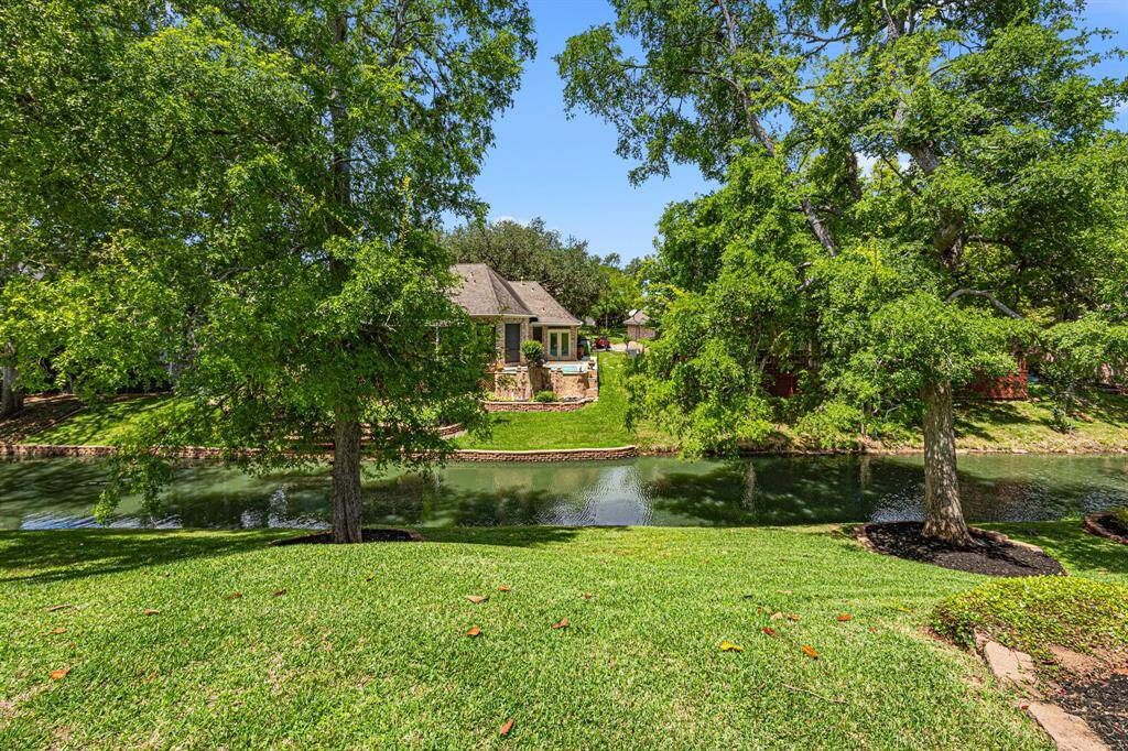 Take a look at this view of the Backyard, with Pecan Lake as the backdrop, surrounded by stunning landscaping and a peaceful atmosphere.