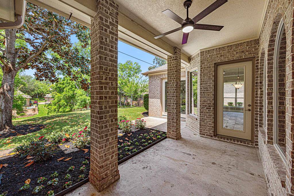 Step outside to the covered Back Patio, featuring a newly installed ceiling fan, gorgeous landscaping, and incredible views of Pecan Lake.
