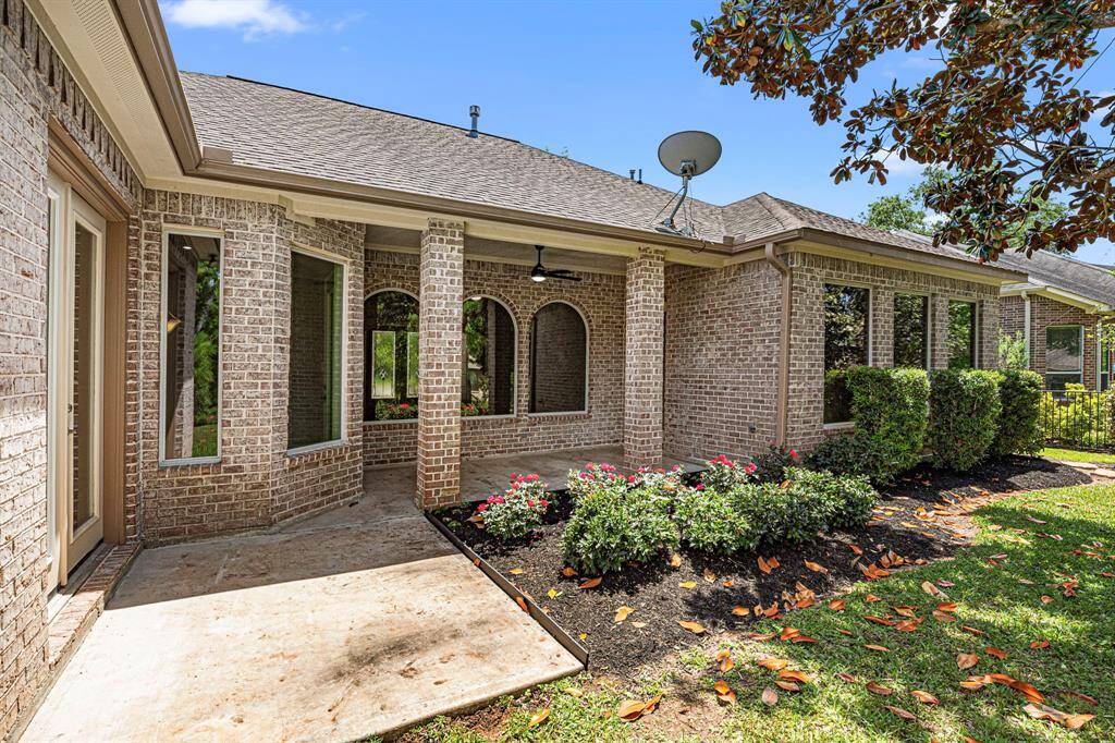 This view shows the backside of the house, highlighting the covered back patio and the added concrete pad for extra seating.