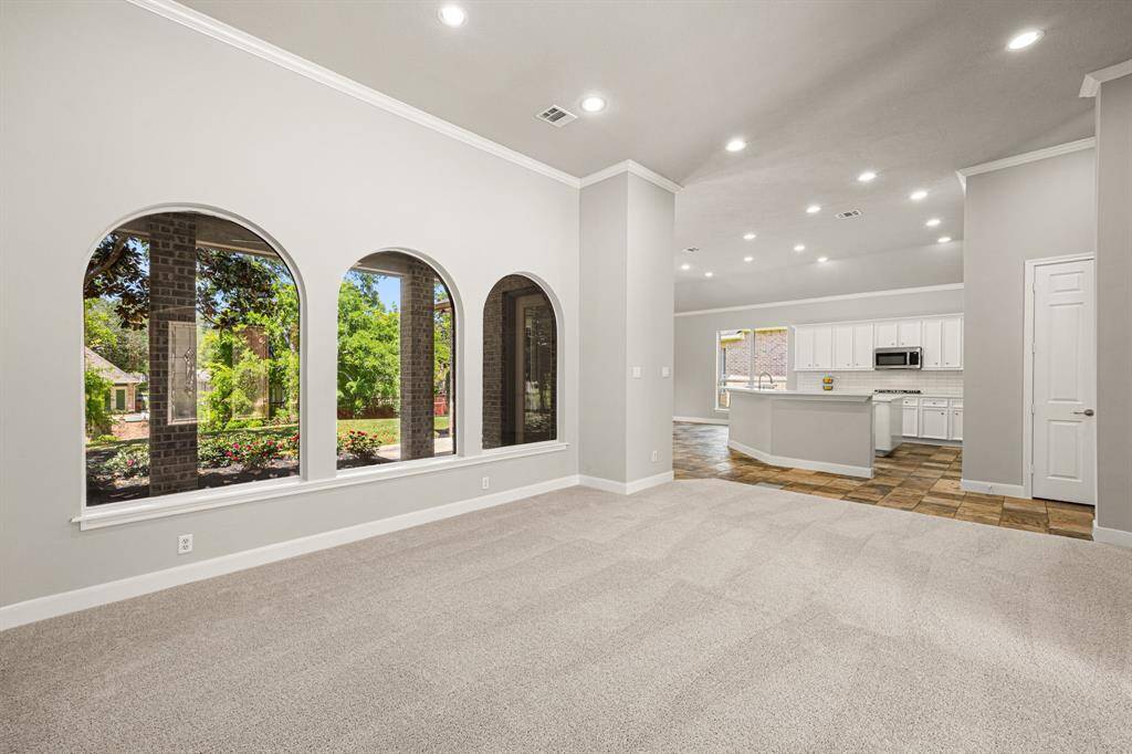 This view, taken from a different angle, looks from the Flex Room toward the Kitchen, highlighting the open floor plan and the seamless connection between the two spaces.