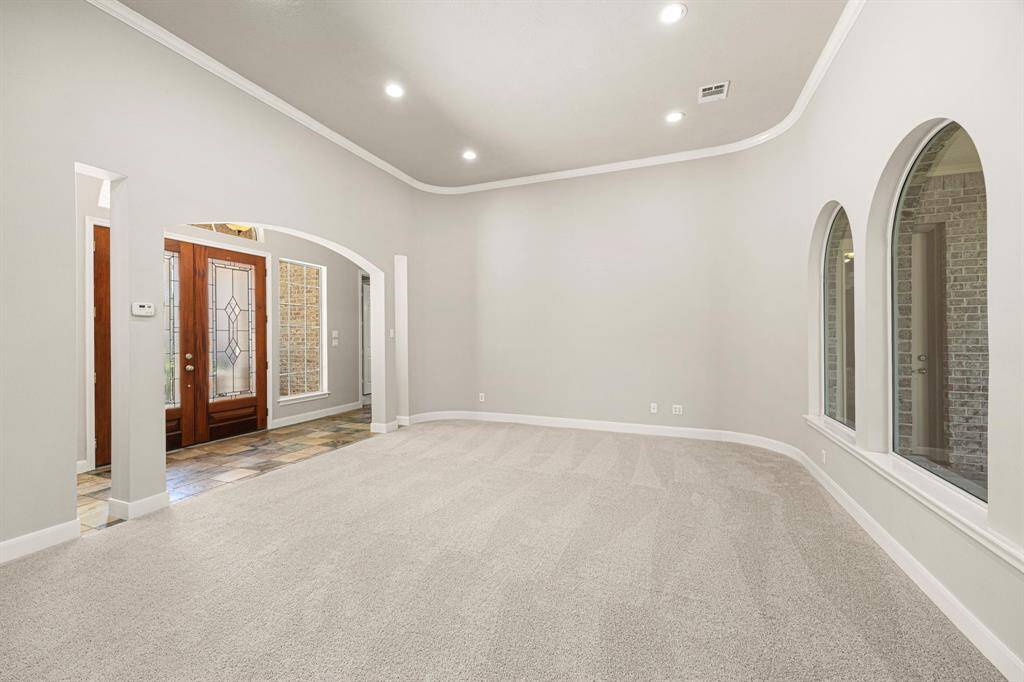 Soothing paint colors and newly installed carpet blend seamlessly to create a calm and inviting atmosphere, complemented by crown molding and slate flooring in the Foyer.