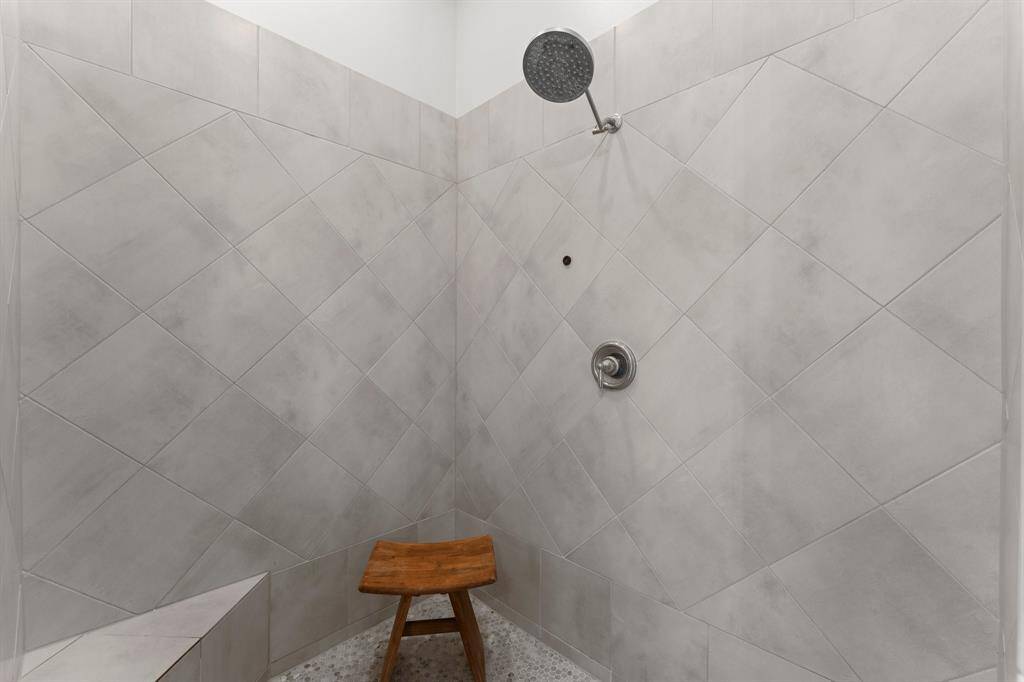 Large walk in shower with bench