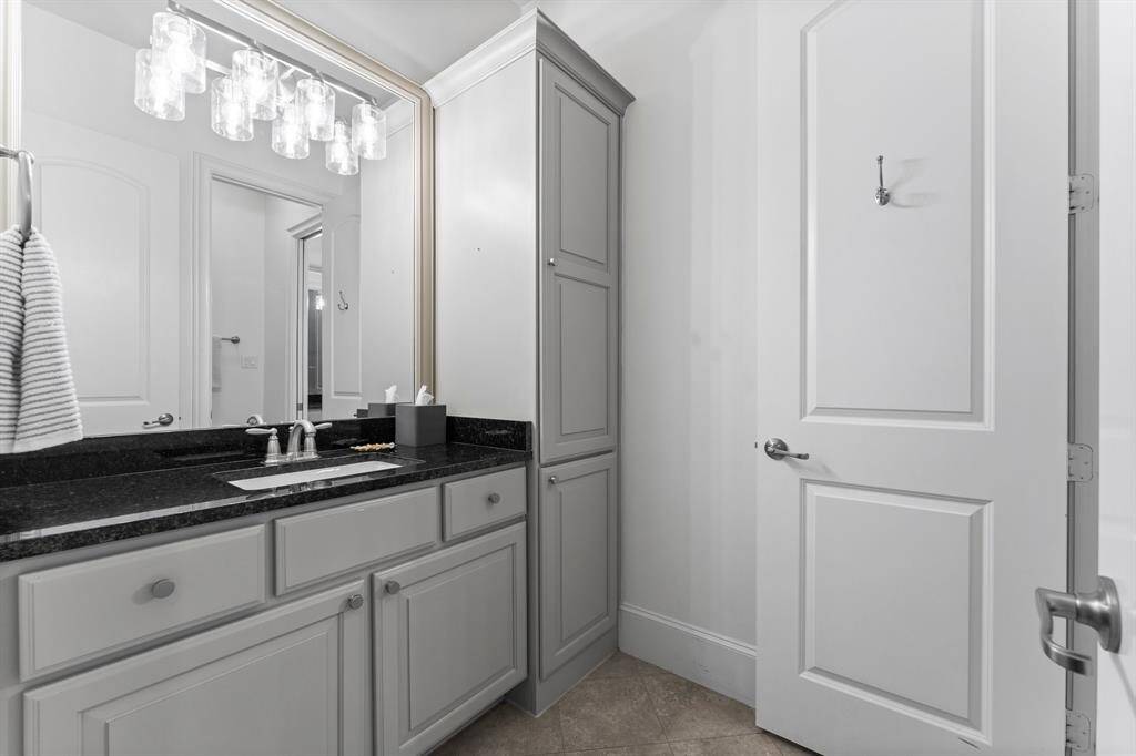 Secondary Bath, sleek counters and modern lighting