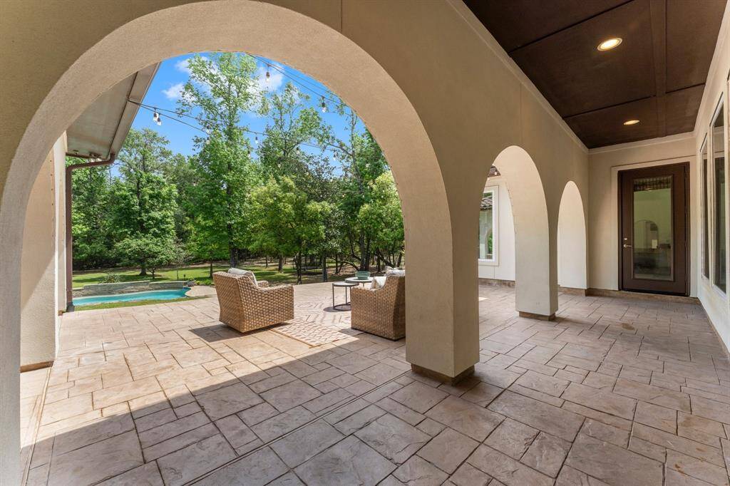 Step into your back yard oasis, with incredible arches, mature trees, pool, spa and outdoor kitchen!