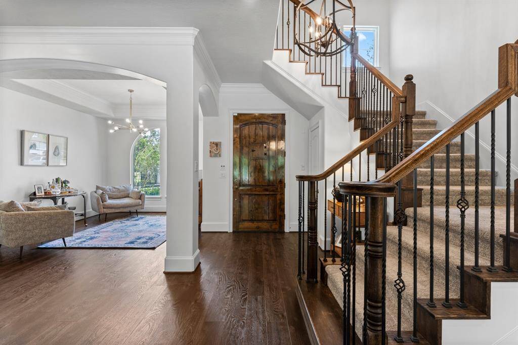 Staircase off the entry, look into a formal dining currently being used as a sitting area.