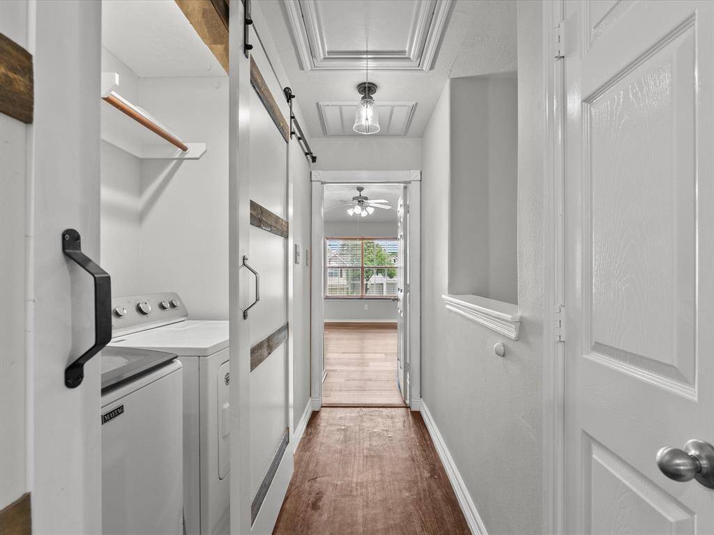 Private laundry room with custom sliding barn doors