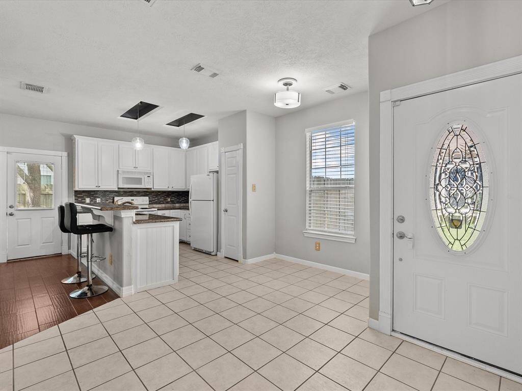 Breakfast area, front entrance and open floor kitchen.