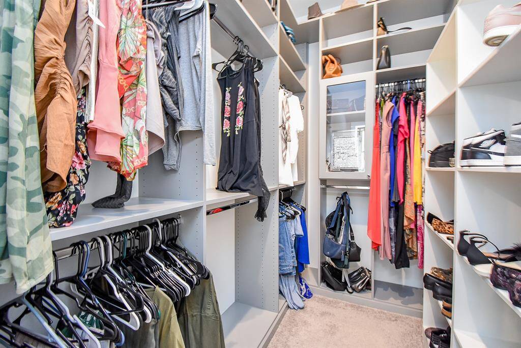 one of the custom walk in primary closets