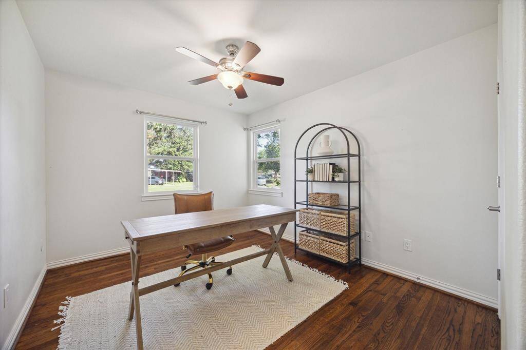 SECONDARY BEDROOM #1- Three additional bedrooms all have hardwoods. This bedroom is staged as a home office.