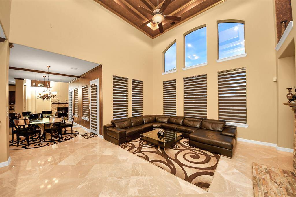 Family room with high ceilings and large sized windows