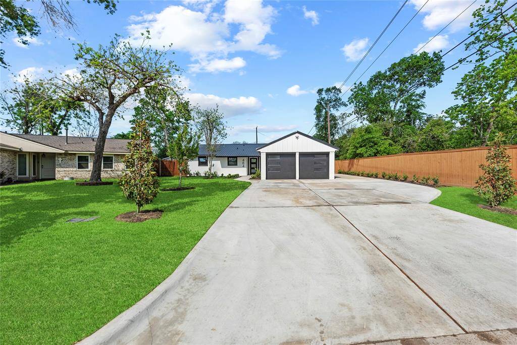 Extra wide extended driveway and beautiful stained custom fence.