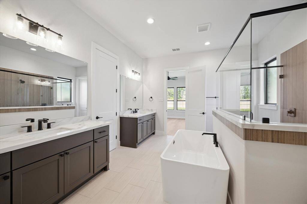 Primary Bath with separate vanities and 2 walk-in closets