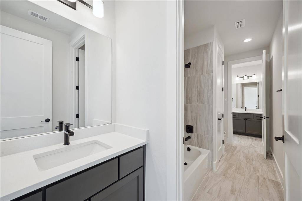Hollywood Bath - 2 vanity areas adjoined by a shower with bathtub, linen closet, and WC