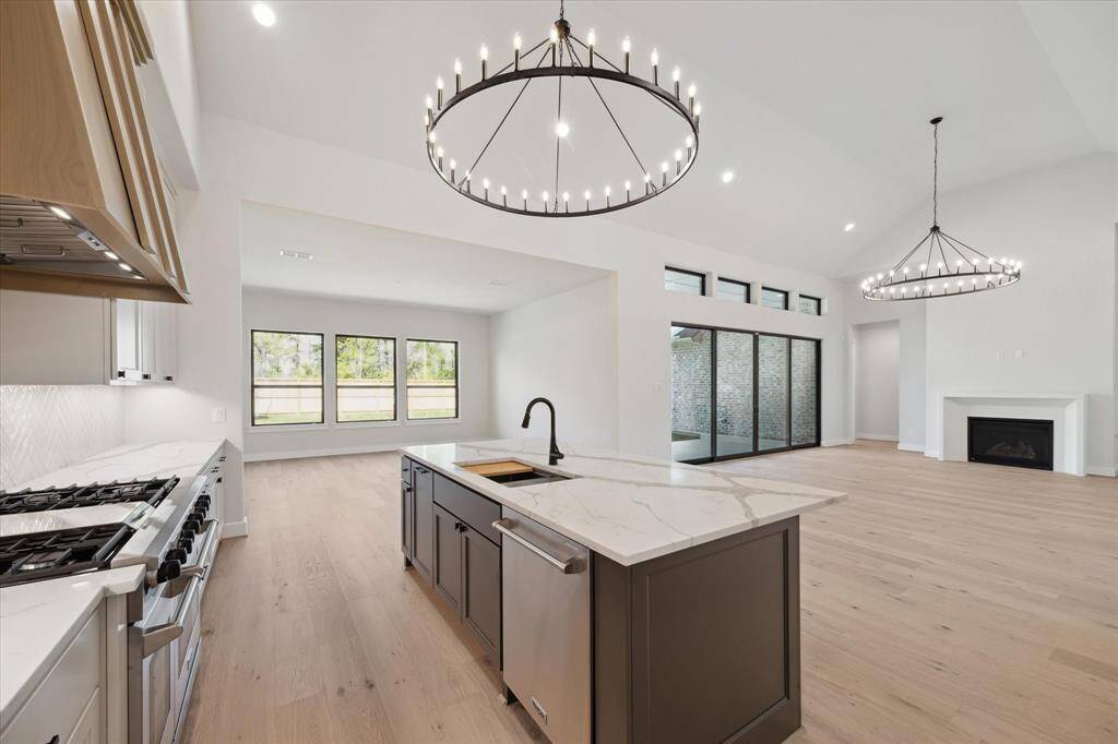 Kitchen features high-end appliances, custom-built cabinetry, stunning Quartz countertops, and massive Island with space for seating.