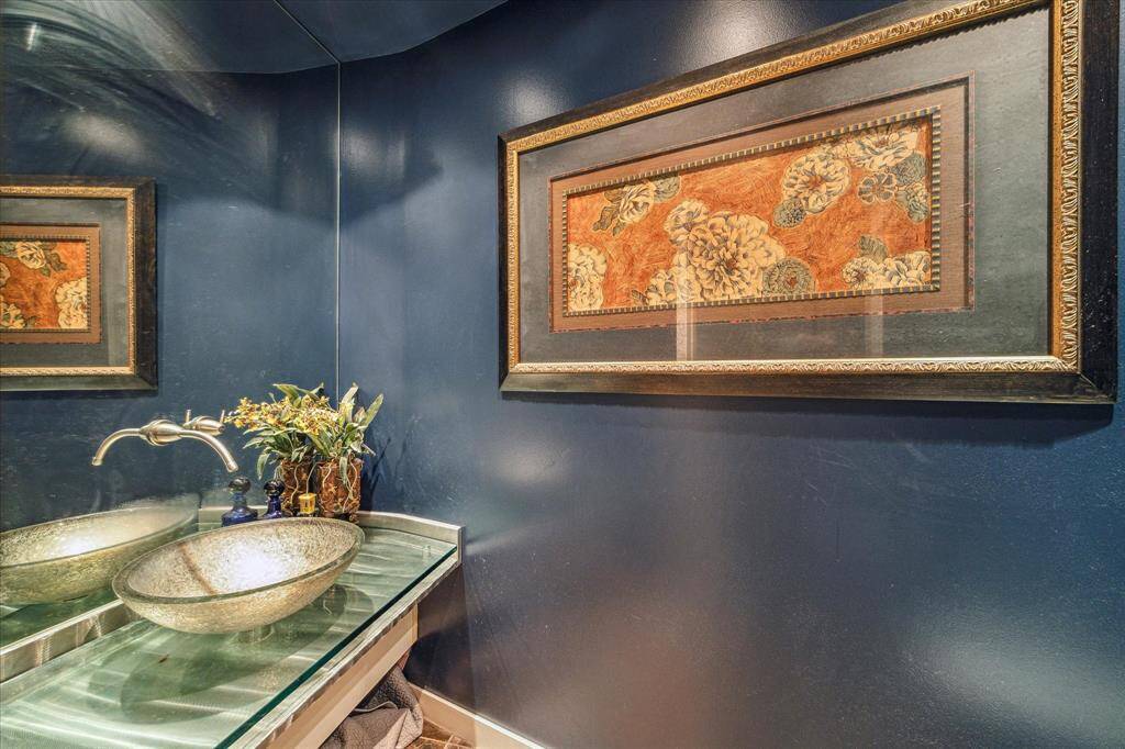 Lovely glass bowl sink in the powder room.