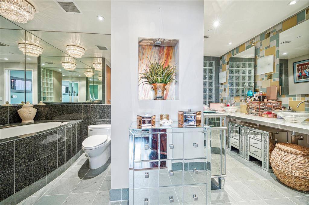 A well appointed bathroom with soaking tub, two sinks and a walk in shower.