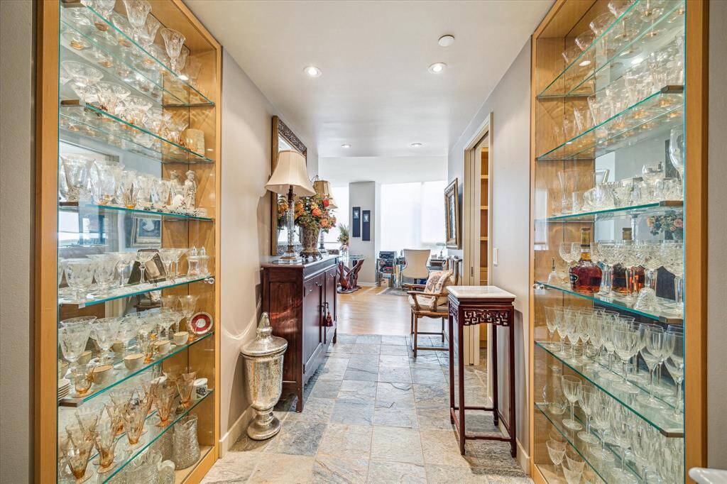 The entry features custom crystal storage cabinets.