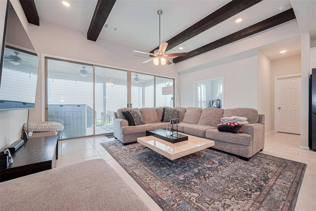 Next to the dining area is the living room which leads to the covered patio. To the back is the study and down the hall is the half bathroom