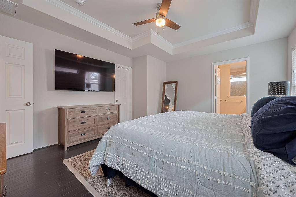 Another view. The walk in closet expands behind the TV and the primary bath is to the right