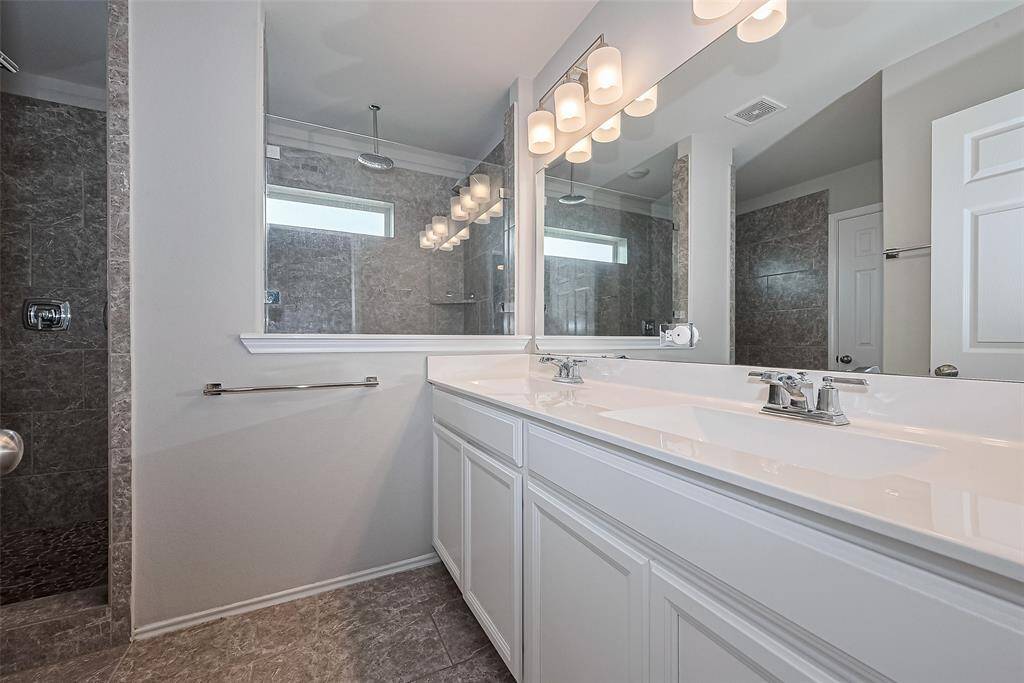 Primary bath with dual sinks and a spa shower