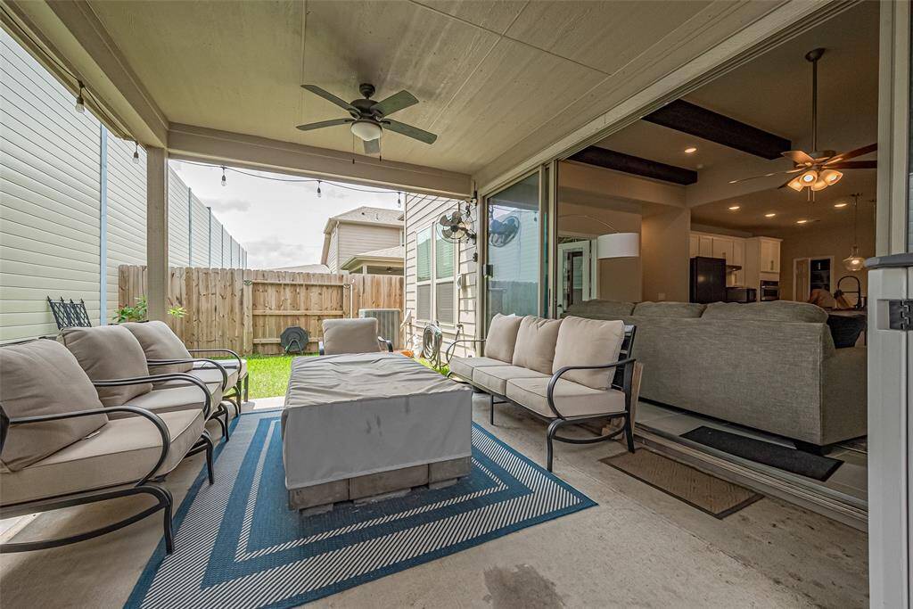 Sliding doors open between the family room to a great outdoor space