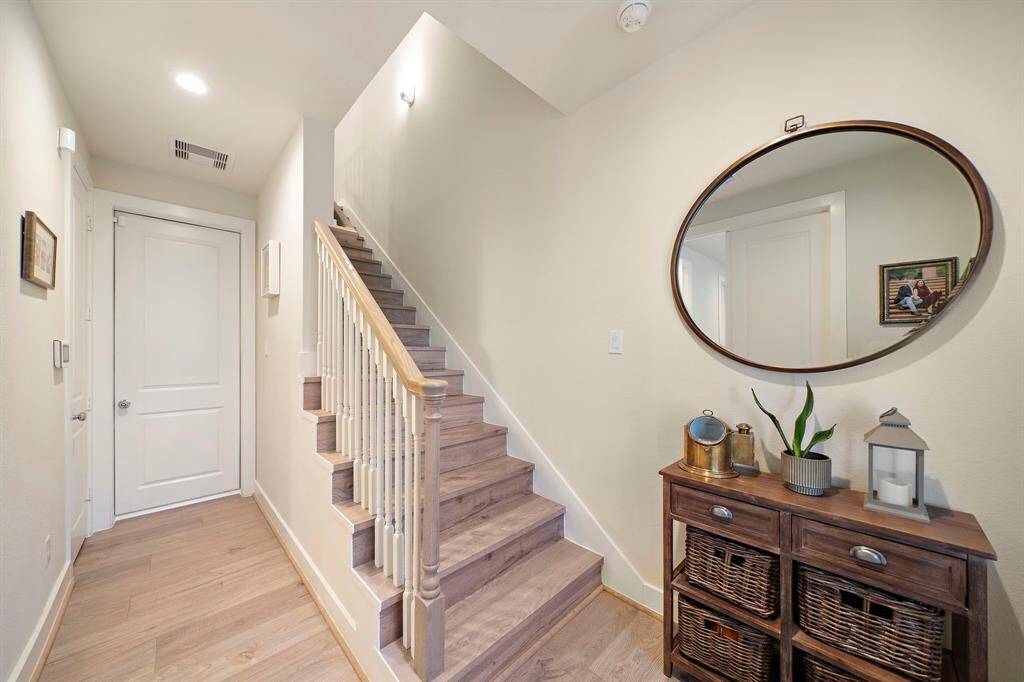 Beautiful entryway at the front door with the bedroom/study to the immediate left, a coat closet just past that and the door leading into the garage straight ahead.