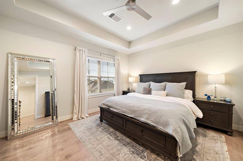 Spacious primary bedroom with recessed ceiling and two walk-in closets!