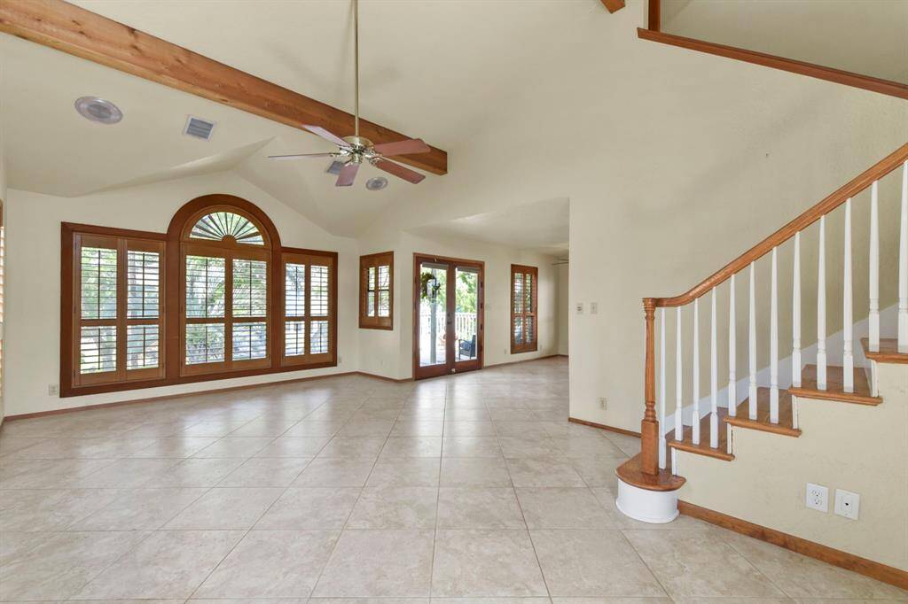 Elegant plantation windows and a soaring cathedral ceiling create a welcoming atmosphere.