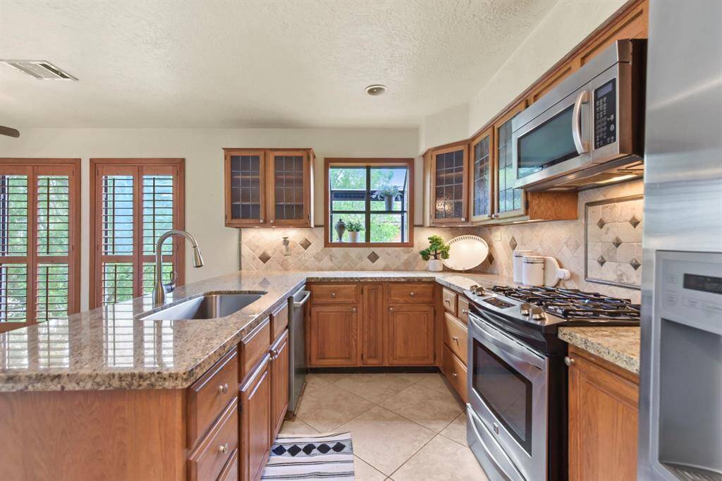 Experience culinary convenience with a modern gas range and built-in microwave.