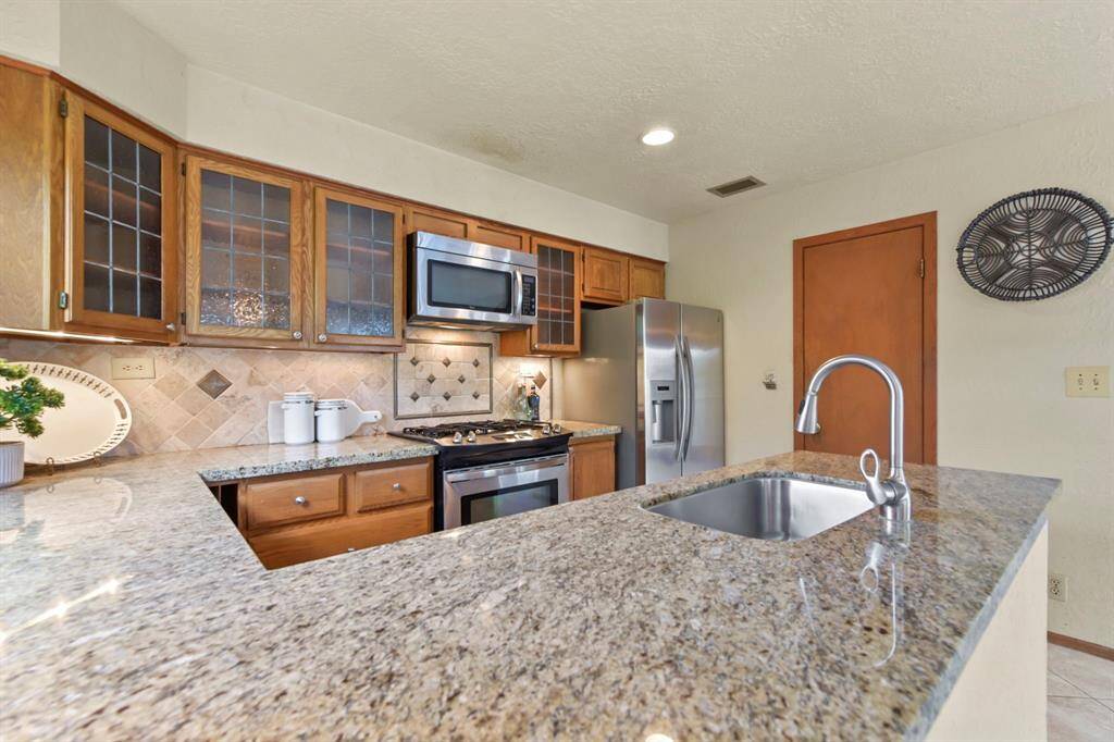 Discover the convenience of a spacious walk-in pantry at the kitchen's end.
