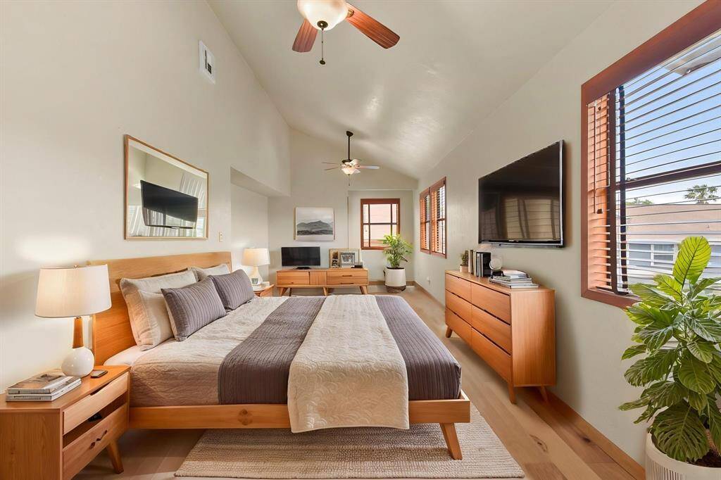 The upper level features a spacious bedroom with versatile potential, easily convertible into two separate rooms.