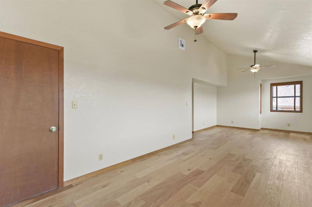 This room features a spacious, wall-length closet for ample storage.