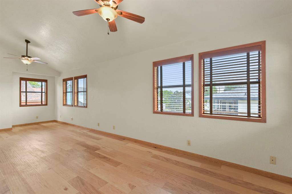 Bright room with abundant natural light and dual ceiling fans.