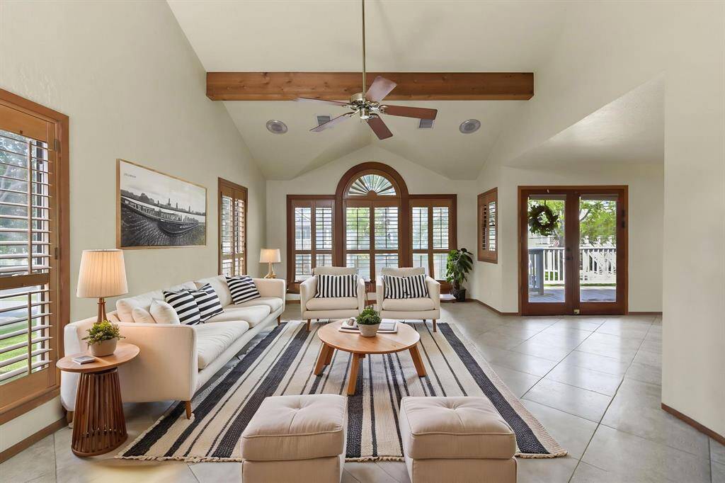 Spacious living room featuring elegant plantation shutters for a bright and inviting atmosphere.