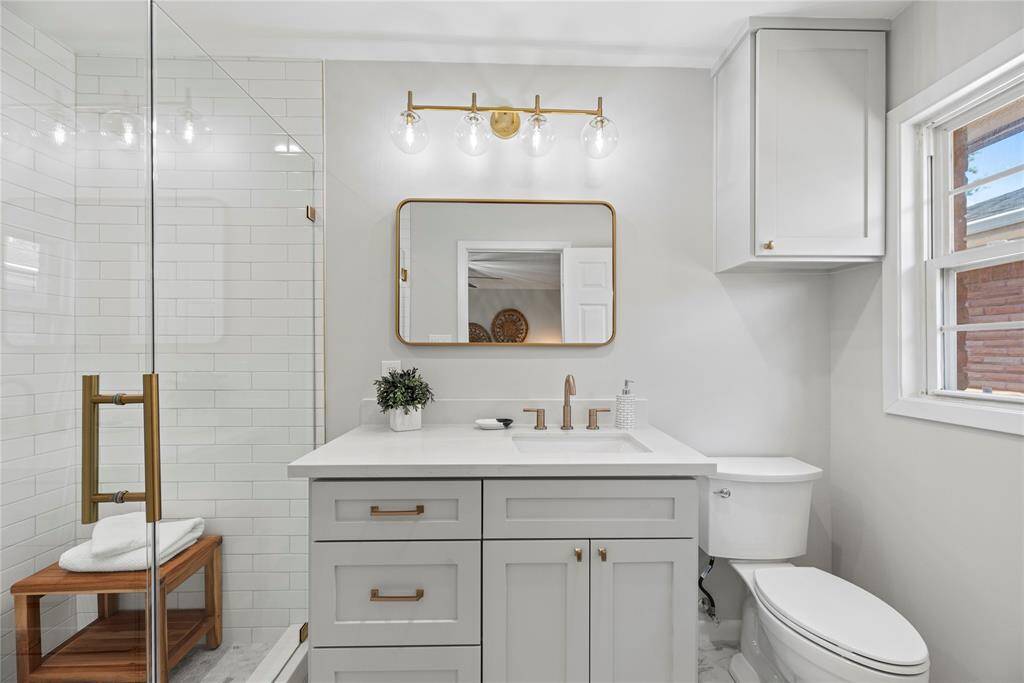 The updated bath features great lighting, a large, glass enclosed shower.