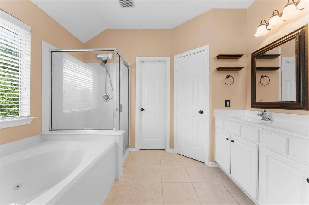 Primary bathroom with double sinks, shower and tub.