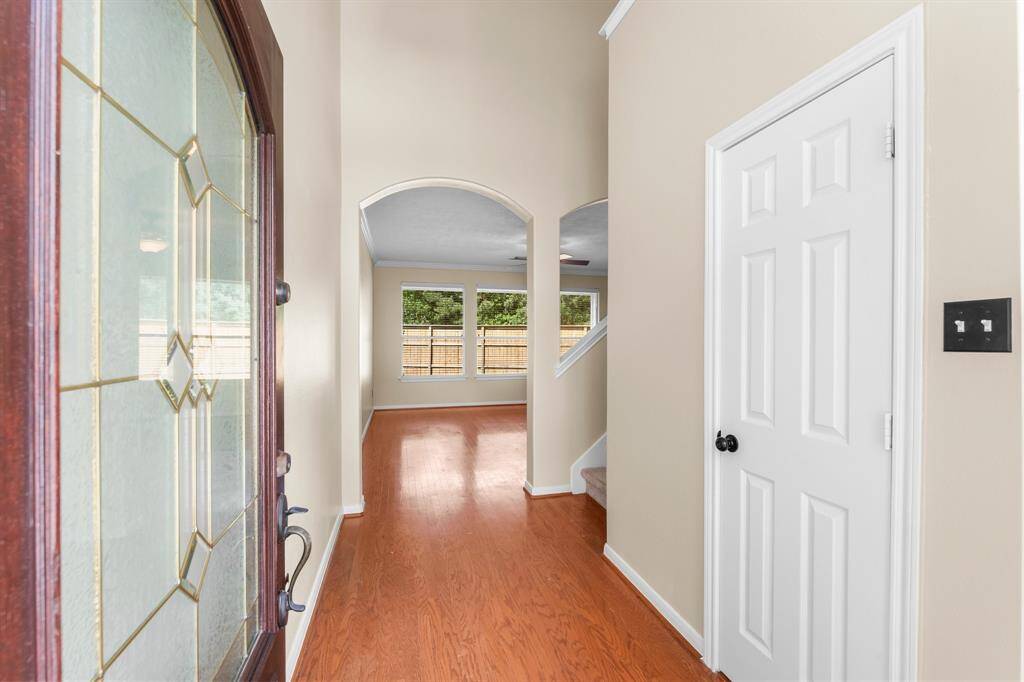 Lovely entrance with neutral colors and beautiful wood floors.