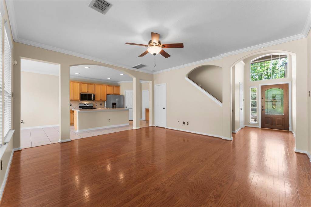 Living area with view of the island kitchen. Storage closet under the stairs.