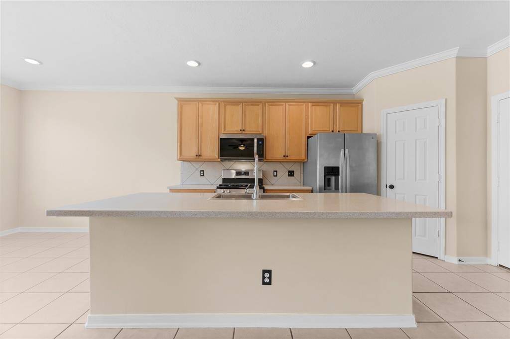 Island kitchen is great for chairs and extra seating.