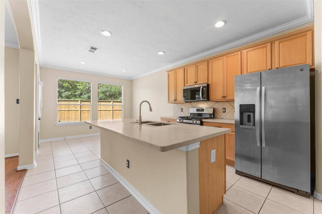 View of the kitchen with all new appliances and kitchen sink.