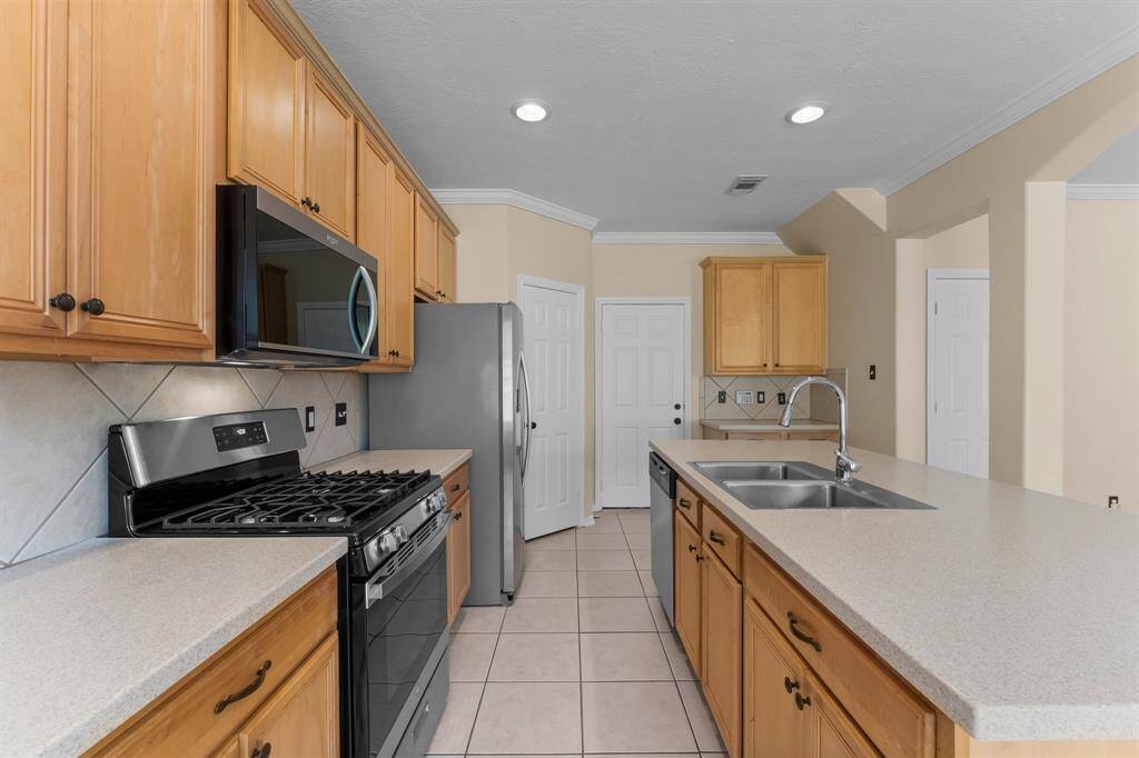 View of the kitchen. Don't miss the walk in pantry and attached 2 car garage.