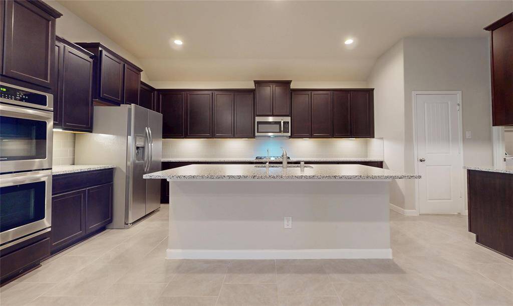Very large kitchen with lots of cabinets and work surface.  Island with room for at least 4 bar stools.