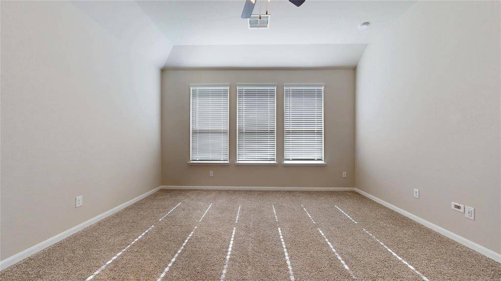 First view of the primary bedroom which faces the back yard.