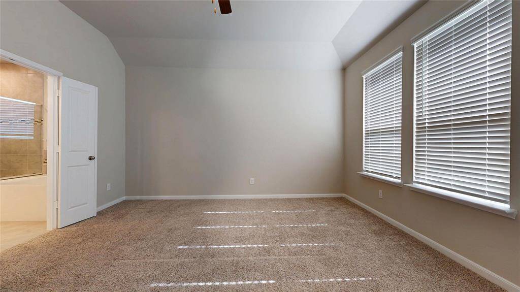 Second view of primary bedroom from the entry doorway.