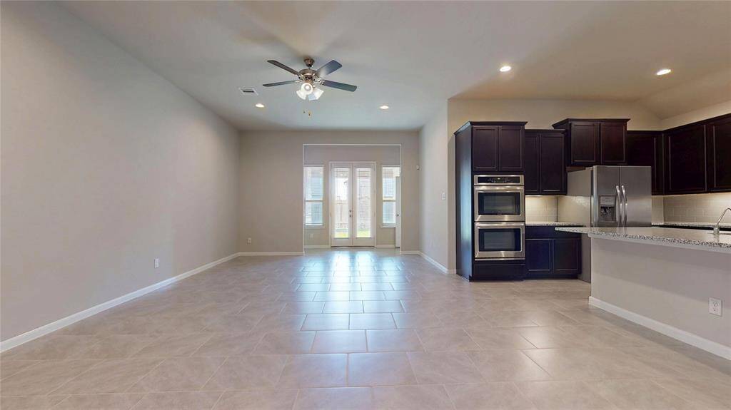 The very large family room (25 ft X 15 ft) is open to the kitchen.  The doors in the background lead to the back porch and yard.