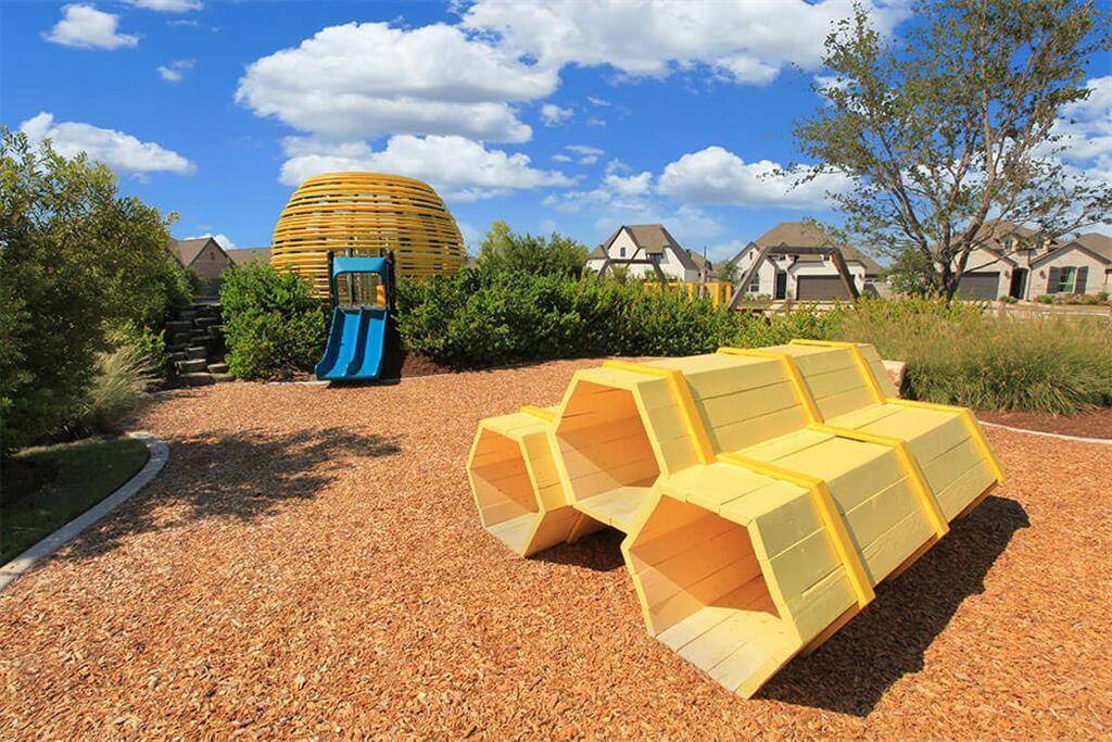 This honeycomb themed playground has slides, swings, and climbing structures for your little ones to safely explore.