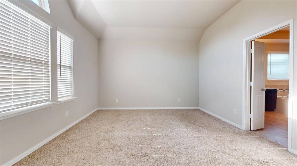 The primary bedroom faces the backyard and enjoys abundant natural light.
